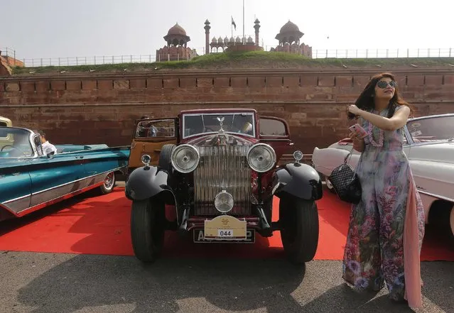 A participant stands next to her 1933 Rolls Royce during a vintage car rally in front of the historic Red Fort in the old quarters of Delhi February 21, 2015. (Photo by Adnan Abidi/Reuters)