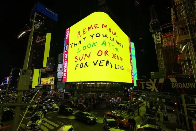 A view of an electronic billboard featuring animated artwork by British artist David Hockney in Times Square on May 01, 2021 in New York City. The new digital piece, titled “Remember that you cannot look at the sun or death for very long”, was unveiled across a network of the world's most iconic outdoor video screens, uniting New York, London, Tokyo, and Seoul throughout May. (Photo by Dia Dipasupil/Getty Images)