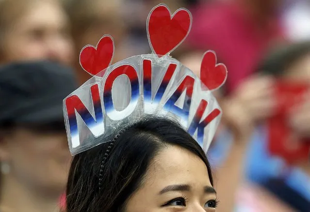 A supporter of Serbia's Novak Djokovic watches his third round match against Italy's Andreas Seppi at the Australian Open tennis tournament at Melbourne Park, Australia, January 22, 2016. (Photo by Issei Kato/Reuters)