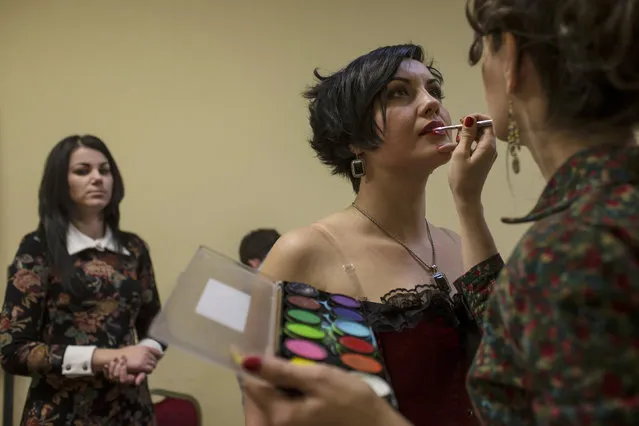 Female soldiers of the self-proclaimed Donetsk People's Republic prepares backstage during a beauty pageant to mark International Women's Day in Donetsk, March 7, 2015. (Photo by Marko Djurica/Reuters)