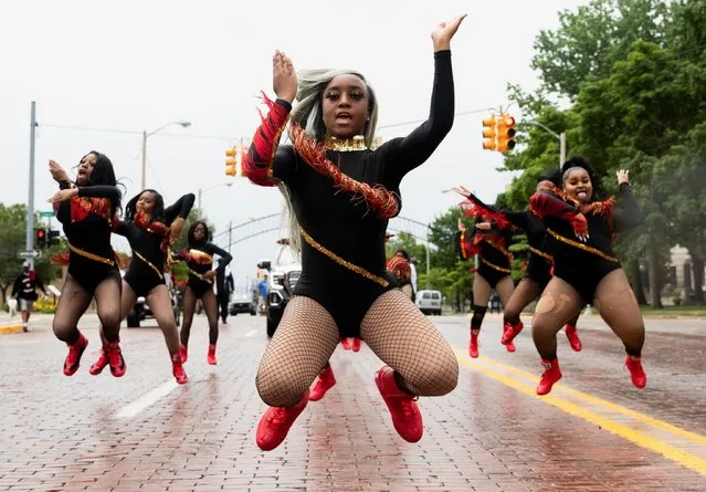 Dance captain Shair'Mae Harris, 17, leads members from “For The Love of Dance Studio” during a parade to celebrate Juneteenth, which commemorates the end of slavery in Texas, two years after the 1863 Emancipation Proclamation freed slaves elsewhere in the United States, in Flint, Michigan, U.S., June 19, 2021. (Photo by Emily Elconin/Reuters)