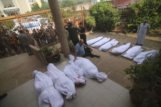 Palestinians gather around the bodies of people killed in Israeli airstrikes during their funeral in Khan Younis, Gaza Strip, Wednesday, October 11, 2023. (Photo by Hatem Ali/AP Photo)