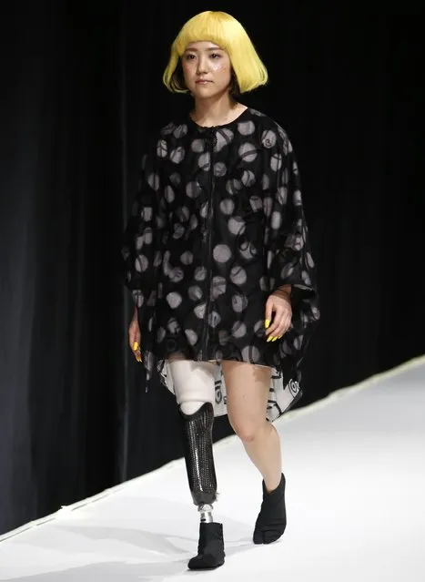 A model with a prosthetic leg presents a creation by designer Takafumi Tsuruta from his Autumn/Winter 2015/2016 collection for his brand tenbo during Tokyo Fashion Week March 18, 2015. (Photo by Yuya Shino/Reuters)