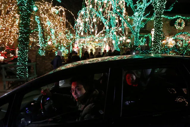 People drive through the Dyker Heights Christmas Lights in the Dyker Heights neighborhood of Brooklyn, New York City, U.S., December 23, 2016. (Photo by Andrew Kelly/Reuters)