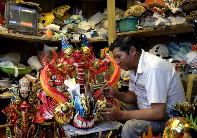 Artisan Fernando Flores retouches a Diablo mask for revelers to wear during Carnival festivities next Saturday in Oruro, Bolivia, February 3, 2016. (Photo by David Mercado/Reuters)