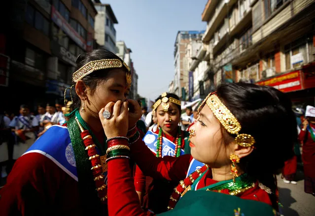 A Gurung girl (R) adjusts her friend's ornament while taking part in Tamu Lhosar or Losar (New Year) parade in Kathmandu, Nepal December 30, 2016. (Photo by Navesh Chitrakar/Reuters)