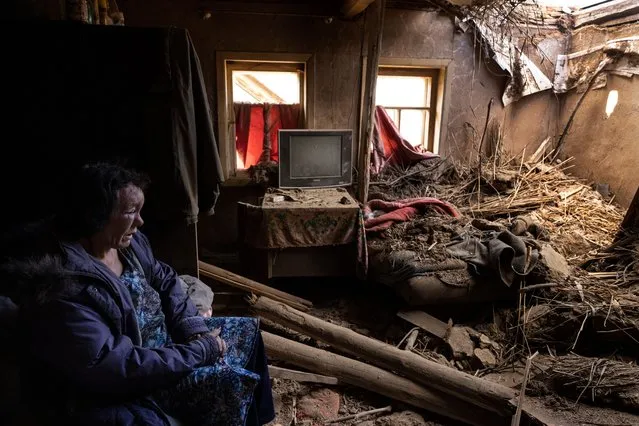Leda Buzinna, 56, sits inside her home that was seriously damaged by shelling overnight when two S-300 missiles hit a rural neighborhood on October 4, 2022 outside of Kramatorsk district in Krasnotorka, Ukraine. Leda has facial injuries that were treated in a local hospital and she was released, her husband injured his leg in the attack. They have been living in the home for 18 years. They will get help for home repair from the government. Leda was sleeping when the missile hit their bedroom. (Photo by Paula Bronstein/Getty Images)