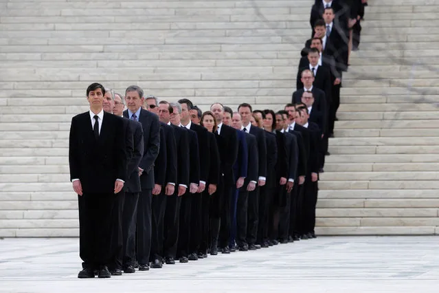 One hundred and eighty law clerks line the stairs in front of the U.S. Supreme Court in anticipation of the arrival of Associate Justice Antonin Scalia's casket at the court building February 19, 2016 in Washington, DC. Justice Scalia will lie in repose in the Great Hall of the high court where visitors will pay their respects. (Photo by Chip Somodevilla/Getty Images)