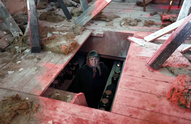 View of an installation showing a destroyed house at the “Material Evidence. Donbass. 365 days” exhibition in Moscow, Russia, April 14, 2015. The exhibition is devoted to the anniversary of the beginning of the military operation in the southeast rebel Ukraine and  focuses on the situation of local residents suffering from the civil war. The exhibition presents photographs taken in the war-torn region and real artifacts brought from the conflict zone. (Photo by Yuri Kochetkov/EPA)