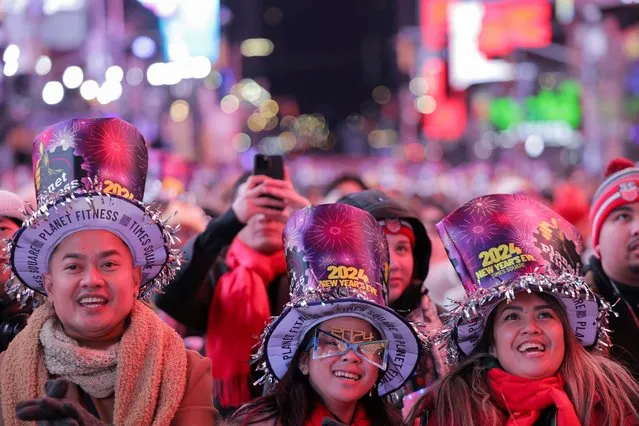 Revellers gather in Times Square during the celebrations of the New Year's Eve, in New York City on December 31, 2023. (Photo by Andrew Kelly/Reuters)