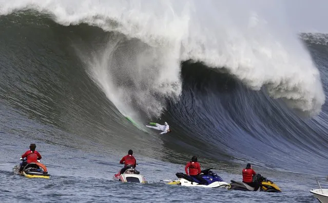 Nic Lamb goes tumbling into a wave during the third heat of the first round of the Mavericks Invitational big wave surf contest Friday, January 24, 2014, in Half Moon Bay, Calif. (Photo by Eric Risberg/AP Photo)