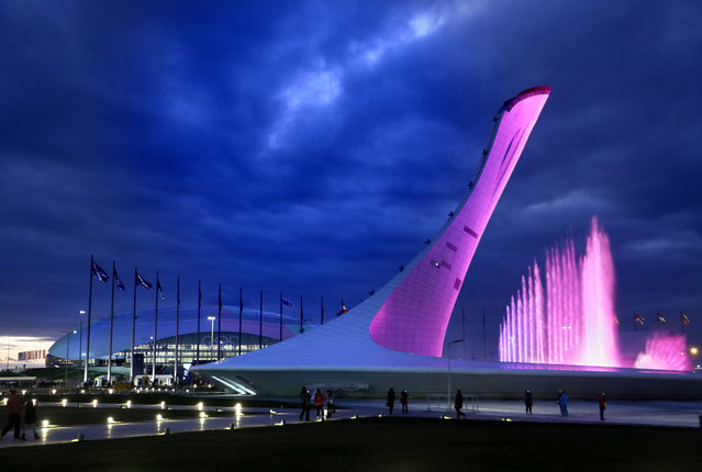 A testing of a water light show is conducted at the Olympic cauldron as the Bolshoy Ice Dome stands at left at the 2014 Winter Olympics, Saturday, February 1, 2014, in Sochi, Russia. (Photo by David Goldman/AP Photo)