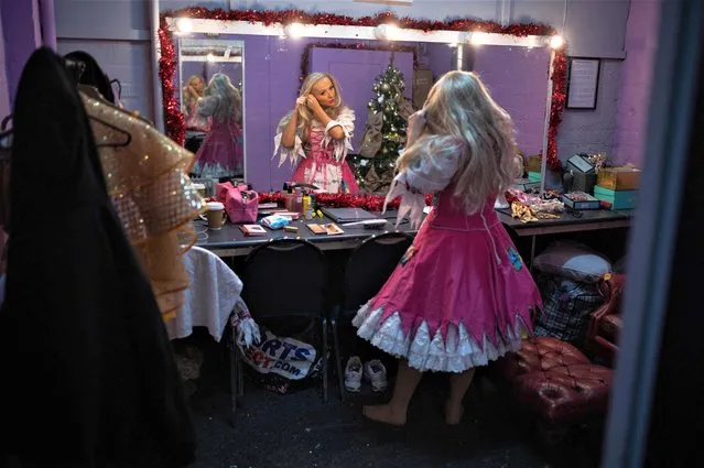 Actor Kimberly Hart-Simpson, playing Cinderella in the Christmas pantomime “Cinderella”, prepares her costume before the start of the show at St Helens Theatre Royal, in St Helens, north west England on December 4, 2022. Built by architect Frank Matcham in the 19th Century the Theatre Royal is the principal theatre in St Helens with 700 seats over two tiers. The production of Cinderella is set to run from December 3, 2022 until January 8, 2023. (Photo by Oli Scarff/AFP Photo)