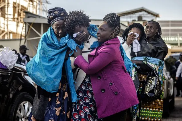 Kelvin Kiptum's mother Mary Kangongo (C) followed by Kelvin Kiptum's wife Asenath Rotich (2nd L) are comforted by other family members while arriving at the mortuary ahead of the beginning of his funeral proceedings in Eldoret, on February 22, 2024. Kenya's world-record holding marathon runner Kelvin Kiptum, a prodigy who ran three of the seven fastest marathons in history and was ranked first among the world's men's marathon runners, tragically died in a car crash in Kenya on February 11, 2024 at the age of 24, in an accident that shocked the world and plunged the East African nation into mourning. (Photo by Luis Tato/AFP Photo)