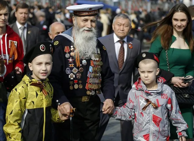 Georgy Shirokov, 91, a Russian veteran of WWII and former sailor of the Baltic Fleet walks in Red Square before the Victory Parade, celebrating 70 years after WWII, in Moscow, Russia, Saturday, May 9, 2015. (Photo by Alexander Zemlianichenko/AP Photo)