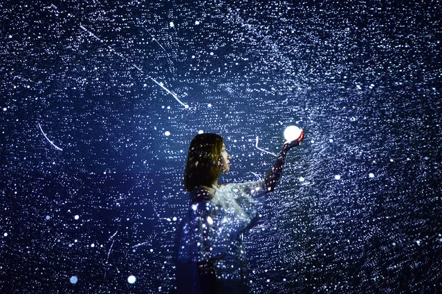 A girl holding an illuminated sphere poses at the exhibition featuring digital art during China International Big Data Industry Expo 2019 at Guiyang International Conference and Exhibition Center on May 28, 2019 in Guiyang, Guizhou Province of China. The China International Big Data Industry Expo 2019, also known as 2019 Big Data Expo, is held on May 26-29 in Guiyang. (Photo by VCG/VCG via Getty Images)
