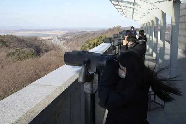 Visitors view the North Korean side from the Unification Observation Post in Paju, South Korea, near the border with North Korea, Friday, December 17, 2021. North Korea on Friday commemorated the 10th anniversary of former leader Kim Jong Il's death with calls for greater public loyalty toward his son and current leader Kim Jong Un, who is struggling to navigate the country out of deepening pandemic-related hardships. (Photo by Ahn Young-joon/AP Photo)