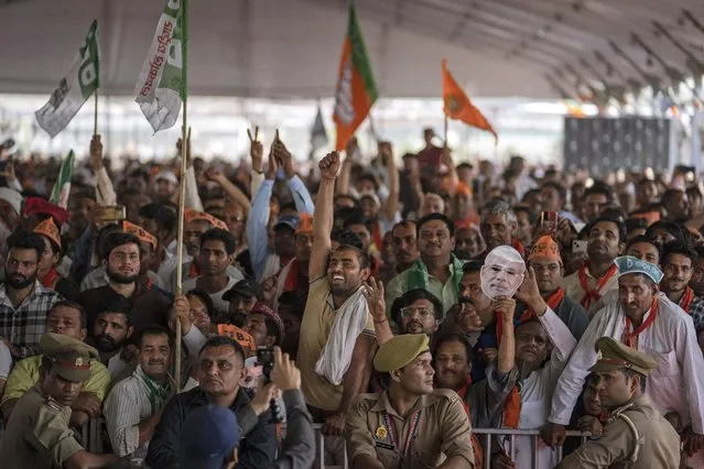 Supporters of India's ruling Bharatiya Janata Party (BJP) react as they listen to Indian Prime Minister Narendra Modi speak at an election rally in Meerut, India, Sunday, March 31, 2024. (Photo by Altaf Qadri/AP Photo)