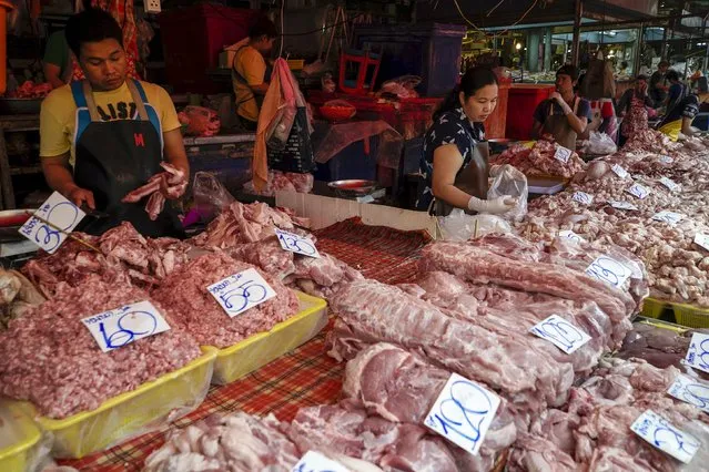 Vendors sell pork at their stall at a market in Bangkok, Thailand, March 31, 2016. Picture taken March 31, 2016. (Photo by Athit Perawongmetha/Reuters)
