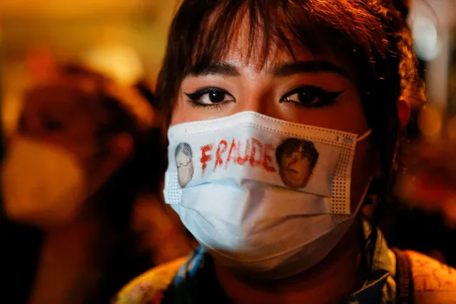 A person wears a face mask reading “Fraud” as demonstrators attend a rally to protest against Bolivian President Luis Arce's government after the detention of former interim President Jeanine Anez, in La Paz, Bolivia, March 15, 2021. (Photo by Manuel Claure/Reuters)