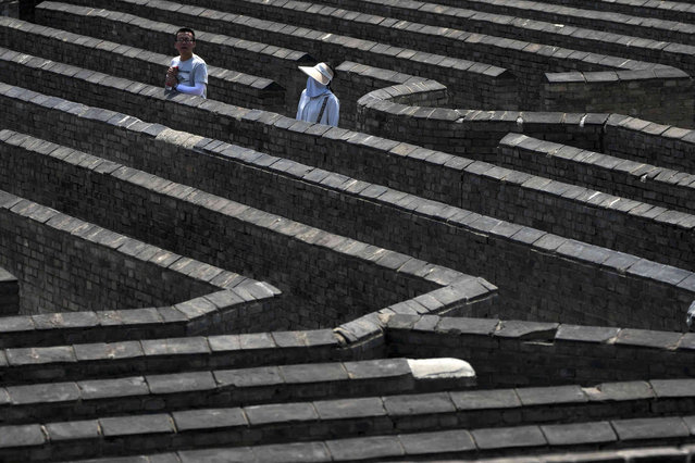 A Chinese couple find their way out in a maze at the Huangyaguan Great Wall in Jizhou, on the outskirts of Beijing, Saturday, May 18, 2024. (Photo by Andy Wong/AP Photo)