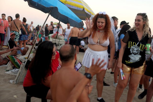 People gather at Copacabana beach to attend Madonna's concert in Rio de Janeiro, Brazil on May 4, 2024. (Photo by Pilar Olivares/Reuters)