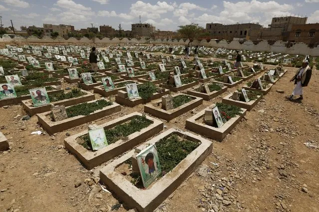 People tour a graveyard for Houthi fighters killed in recent fighting, during the first day of a ceasefire in Yemen's capital Sanaa April 11, 2016. (Photo by Khaled Abdullah/Reuters)