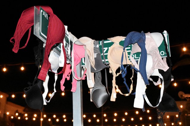 A view of undergarments hanging on a street sign during a protest to mark International Women's Day in Ciudad Juarez, Mexico on March 8, 2023. (Photo by Elizabeth Ramos/Reuters)