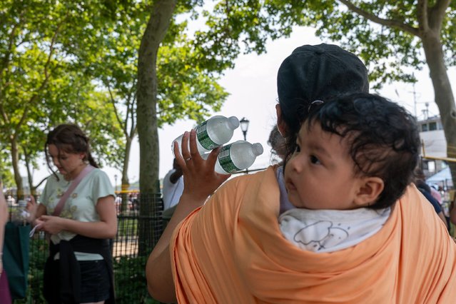 A woman sells water on a hot afternoon in Manhattan on July 08, 2024 in New York City. New Yorkers descend on area beaches, parks, pools and cooling centers as the city experiences its second heat wave of the summer season. (Photo by Spencer Platt/Getty Images)