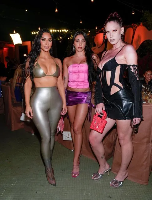 Kim Kardashian wears a metallic silver outfit as she parties with Madonna’s daughter Lourdes (C) at the SKIMS SWIM Miami pop-up dinner at SWAN on Saturday, March 19, 2022 in Miami, Florida. (Photo by J. Lee/Getty Images for ABA)