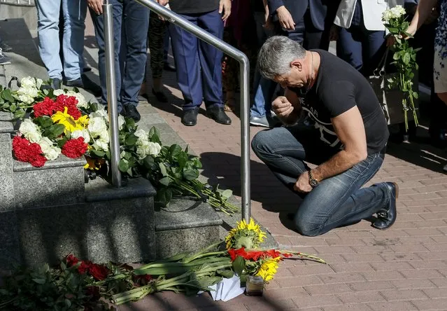 A man prays outside the Dutch embassy to commemorate the victims of the downing of Malaysia Airlines MH17 in eastern Ukraine a year ago, in Kiev, Ukraine July 17, 2015. (Photo by Gleb Garanich/Reuters)