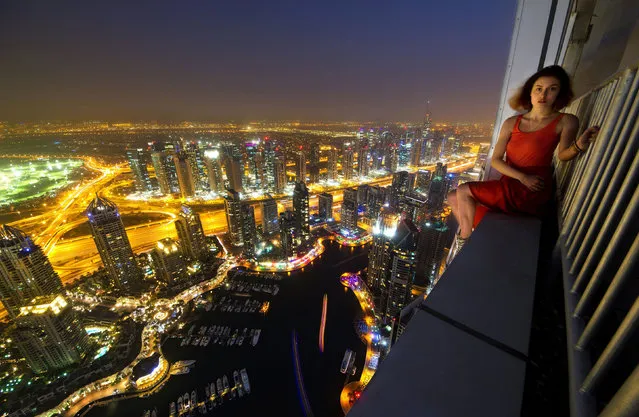 Alexander caught his friend on camera, sitting on the ledge of the tower. (Photo by Alexander Remnev/Caters News)