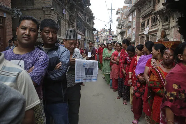 Nepalese stand in a queue to cast their votes at a polling station during the local election in Bhaktapur, Nepal, Sunday, May 14, 2017. Nepalese lined up to vote Sunday for representatives in municipality and village council positions held in the Himalayan nation for the first time in two decades. (Photo by Niranjan Shrestha/AP Photo)