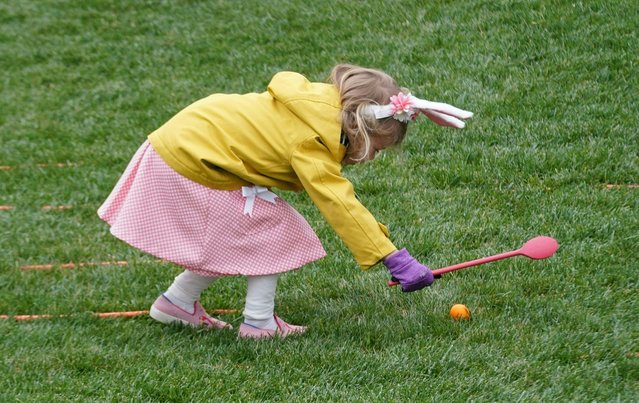 Kids take part in the annual White House Easter Egg Roll on the South Lawn of the White House in Washington, DC on April 18, 2022. (Photo by Stefani Reynolds/AFP Photo)