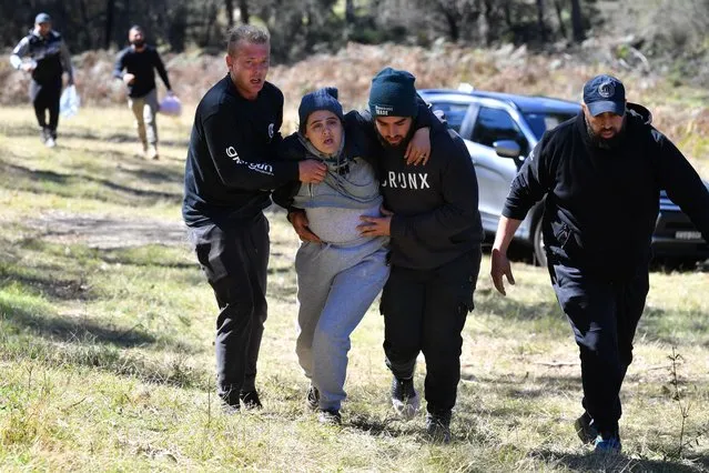 Emotional scenes as Kelly Elfalak (centre), the mother of 3 year old missing boy AJ Elfalak, is helped by family and friends as she rushes to the site where AJ has been found alive on the family property near Putty south west of Sydney, Monday, September 6, 2021. Three year old AJ has been missing for 4 days with a massive search effort being launched by NSW Police, SES and the RFS. (Photo by Dean Lewins/AAP Image)