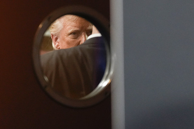 Republican presidential nominee former President Donald Trump is seen through a window in a door before speaking at a campaign event at ll Toro E La Capra, Friday, August 23, 2024, in Las Vegas. (Photo by Julia Nikhinson/AP Photo)