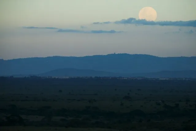 The moon rises over the Nairobi National Park as seen from the Impala Observation Point, as Secretary of State John Kerry visits, Sunday, May 3, 2015, in Nairobi, Kenya. (Photo by Andrew Harnik/Reuters)