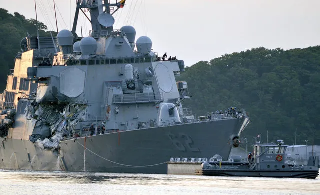 In this Saturday, Junes 17, 2017 photo, released by the U.S. Navy, the damaged USS Fitzgerald is towed into port at the U.S. Naval base in Yokosuka, southwest of Tokyo, Japan, after the Navy destroyer collided with a merchant ship. Acting Secretary of the Navy Sean Stackley says the Navy is deeply saddened and promised a full investigation into a collision between the destroyer and a container ship off Japan that killed seven sailors. (Photo by Spc. 1st Class Peter Burghart/U.S. Navy via AP Photo)