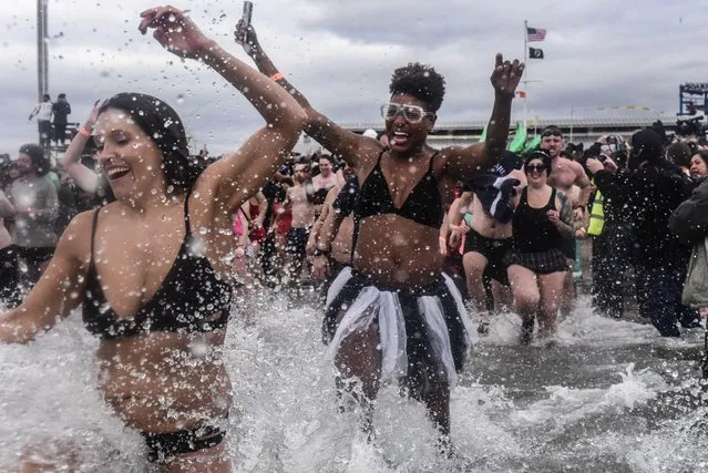 People run into the Atlantic ocean during the annual Polar Bear plunge at Coney Island in New York, New York, U.S., January 1, 2020. (Photo by Stephanie Keith/Reuters)
