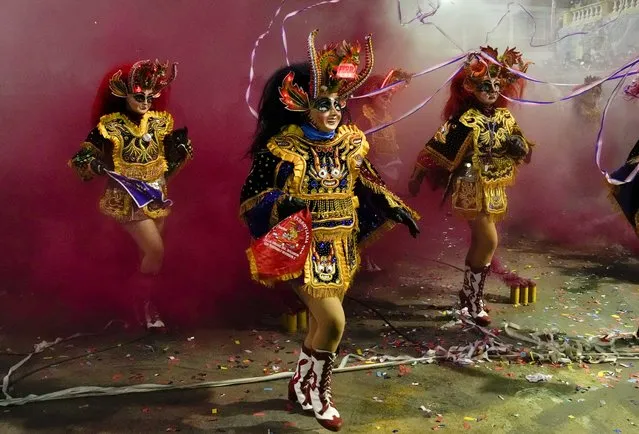 Andrea Hinojosa, center, dressed as devil perform the “Diablada de Oruro” dances in Oruro, Bolivia, Friday, October 1, 2021. Hinojosa says “It was difficult during the COVID-19 pandemic, I missed not being able to dance at the Oruro carnival, I remembered with nostalgia watching the videos of previous years how we danced, today the joy is back, we are dancing La Diablada again”. (Photo by Juan Karita/AP Photo)