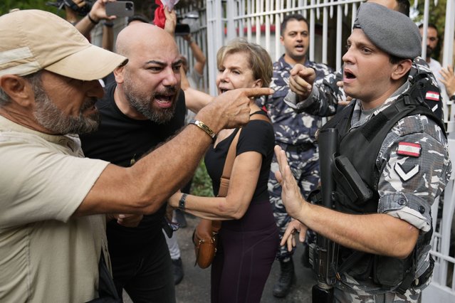 A Lebanese police officer blocks protesters from entering the court building, as they protest against Riad Salameh, the former governor of Lebanon's Central Bank, in Beirut, Lebanon, Monday, September 9, 2024. (Photo by Hussein Malla/AP Photo)