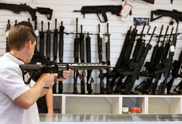 A prospective buyer examines an AR-15 at the “Ready Gunner” gun store in Provo, Utah, U.S., June 21, 2016. (Photo by George Frey/Reuters)