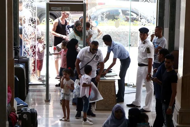 Security personnel search people as they enter 'Sunny Days El Palacio' resort in Hurghada, 450km south east of Cairo, Egypt, 15 July 2017. A day earlier, two German female tourists were killed and four other female tourists, one Czech, two Armenian, and one with an unconfirmed nationality wounded after the man attacked them at the Zahabia hotel and Sunny Days El Palacio resort with a knife. According to a statement from the Egyptian Interior Ministry, the assailant swam from a nearby public beach. The assailant was captured and is being questioned by the police with his motive not yet clear. (Photo by EPA/EFE/Stringer)