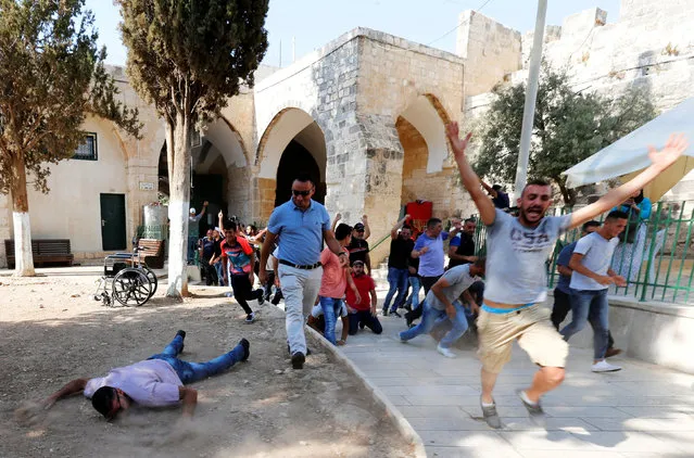Palestinians react as they enter the compound known to Muslims as Noble Sanctuary and to Jews as Temple Mount after Israel removed all security measures it had installed at the compound, in Jerusalem's Old City July 27, 2017. (Photo by Muammar Awad/Reuters)