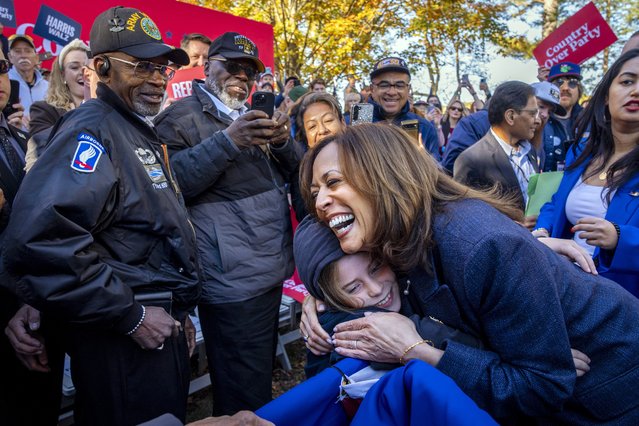 Democratic presidential nominee Vice President Kamala Harris hugs a child after speaking during a campaign event at Washington Crossing Historic Park, in Washington Crossing, Pa., Wednesday, October 16, 2024. (Photo by Jacquelyn Martin/AP Photo)