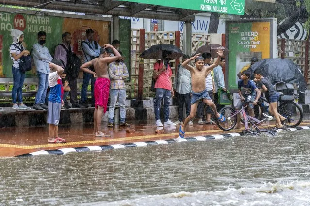 Children play as it rains in New Delhi Thursday, June 30, 2025. India's monsoon season runs from June to September. (Photo by Rajesh Kumar Singh/AP Photo)