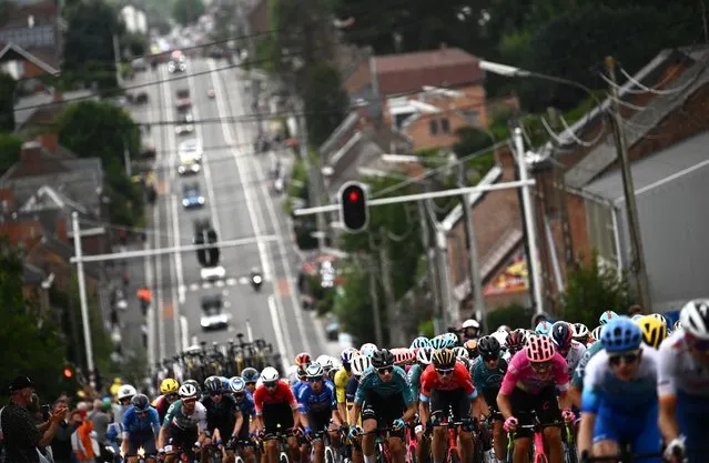 The pack of riders cycles during the 6th stage of the 109th edition of the Tour de France cycling race, 219,9 km between Binche in Belgium and Longwy in northern France, on July 7, 2022. (Photo by Marco Bertorello/AFP Photo)