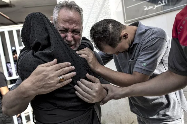Relatives of Muhammad Hassouna, who was killed in an Israeli airstrike mourn before his funeral outside a hospital in Rafah, in the southern Gaza Strip, Sunday, August 7, 2022. An Israeli airstrike in Rafah killed a senior commander in the Palestinian militant group Islamic Jihad, authorities said Sunday, its second leader to be slain amid an escalating cross-border conflict. (Photo by Fatima Shbair/AP Photo)
