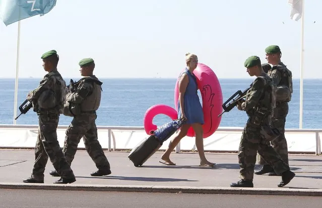 Soldiers patrols on the Promenade des Anglais in Nice, southern France, Wednesday, July 20, 2016. Joggers, cyclists and sun-seekers are back on Nice's famed Riviera coast, a further sign of normal life returning on the Promenade des Anglais where dozens were killed in last week's Bastille Day truck attack. (Photo by Claude Paris/AP Photo)