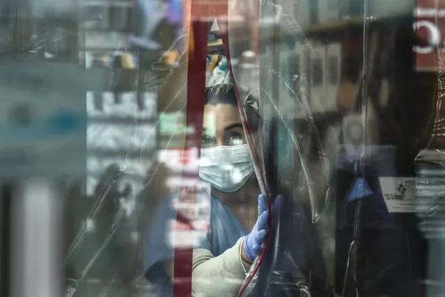 A pharmacist works while wearing personal protective equipment in the Elmhurst neighborhood on April 1, 2020 in New York City. With more than 75,000 confirmed cases of COVID-19 and more than 1,000 deaths, New York City has become the epicenter of the outbreak in the United States. (Photo by Stephanie Keith/Getty Images)
